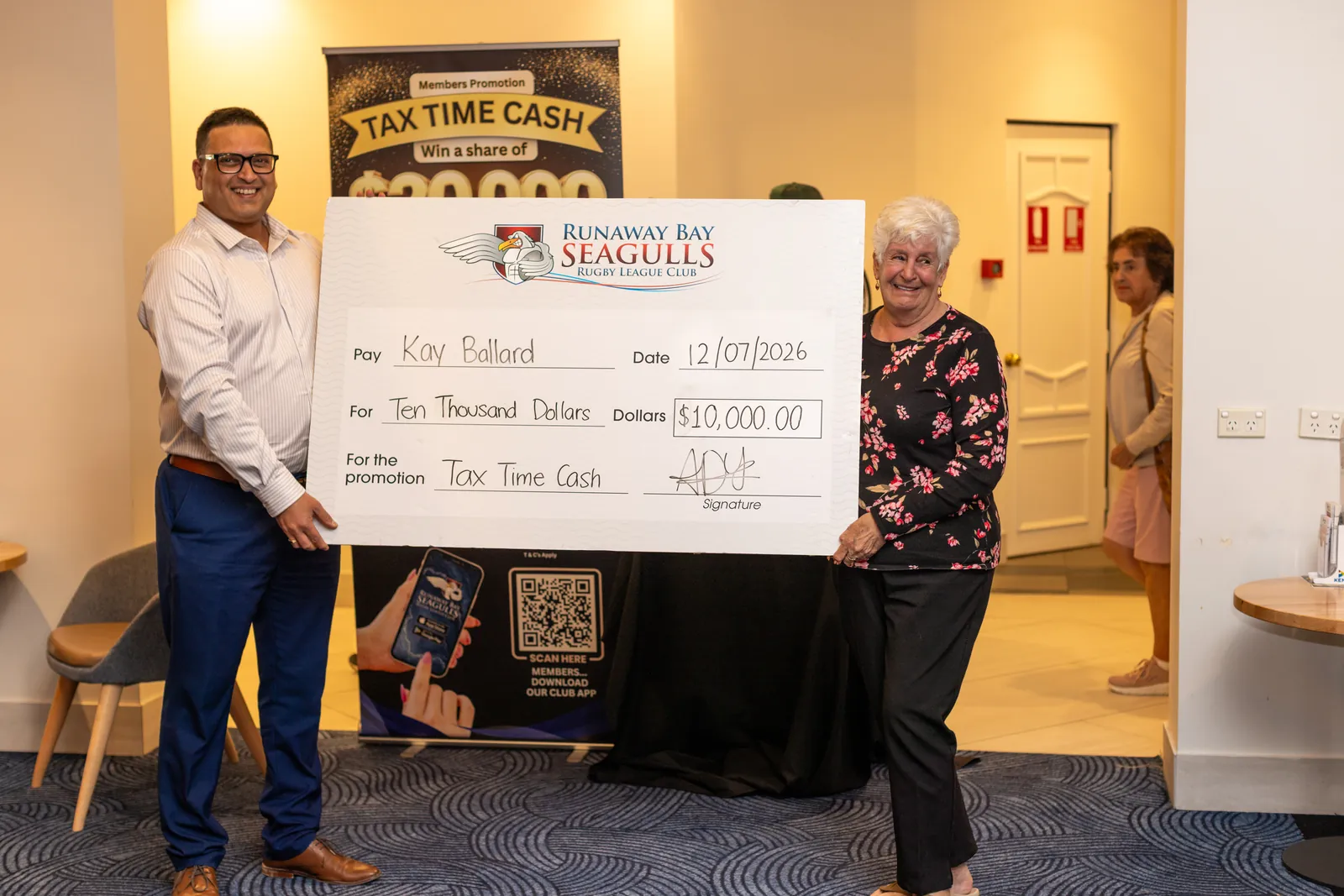 A lucky member taking home $10,000 in a club promotion